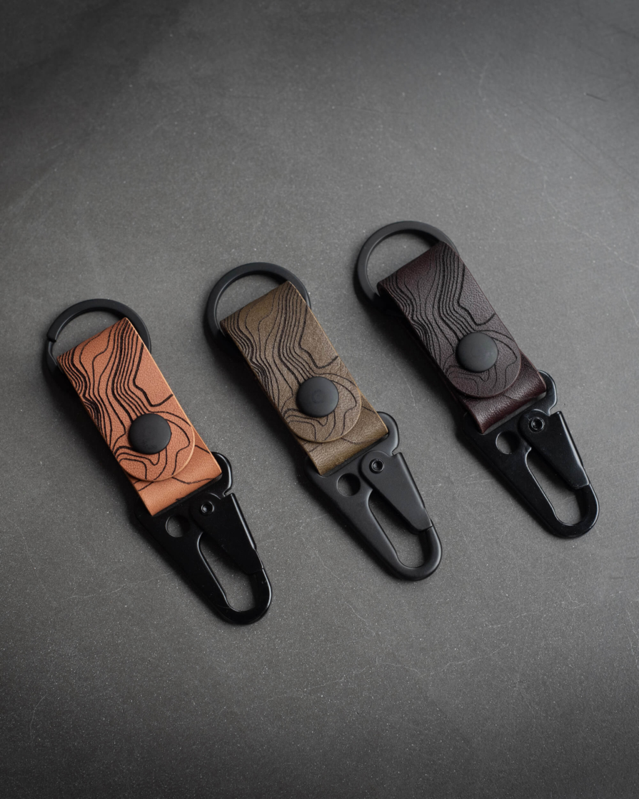 Topographic leather keychain in tan, olive and dark brown