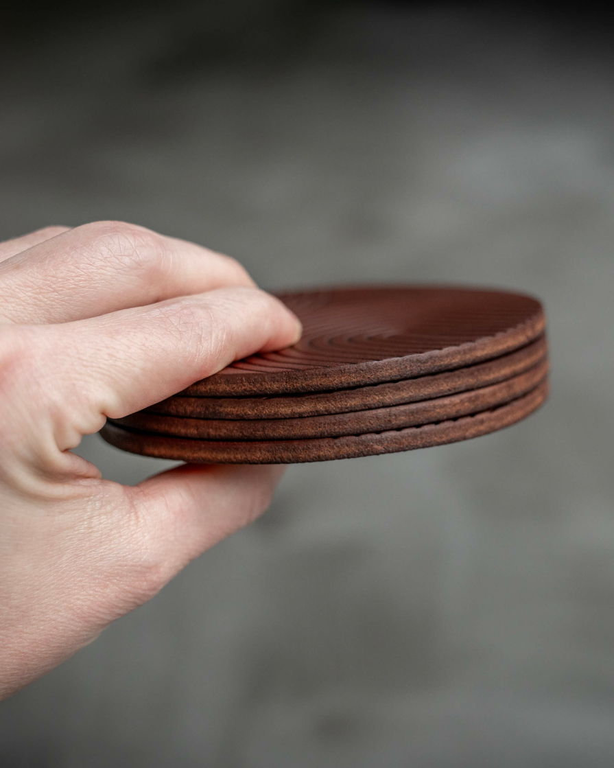 Brown leather coasters featuring modern arch pattern debossed on the surface. Cut from 10oz Thick Leather.