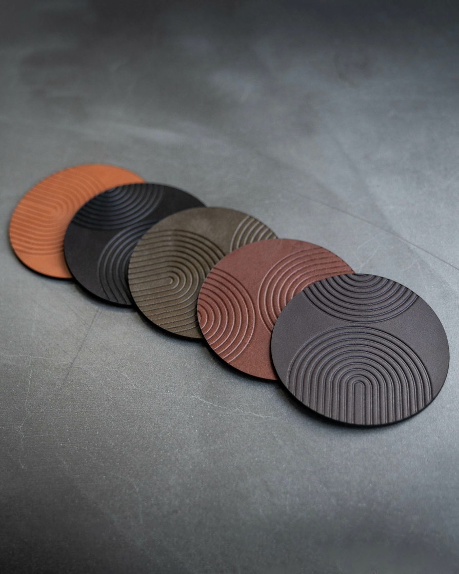 leather coasters featuring modern arch pattern debossed on the surface.
